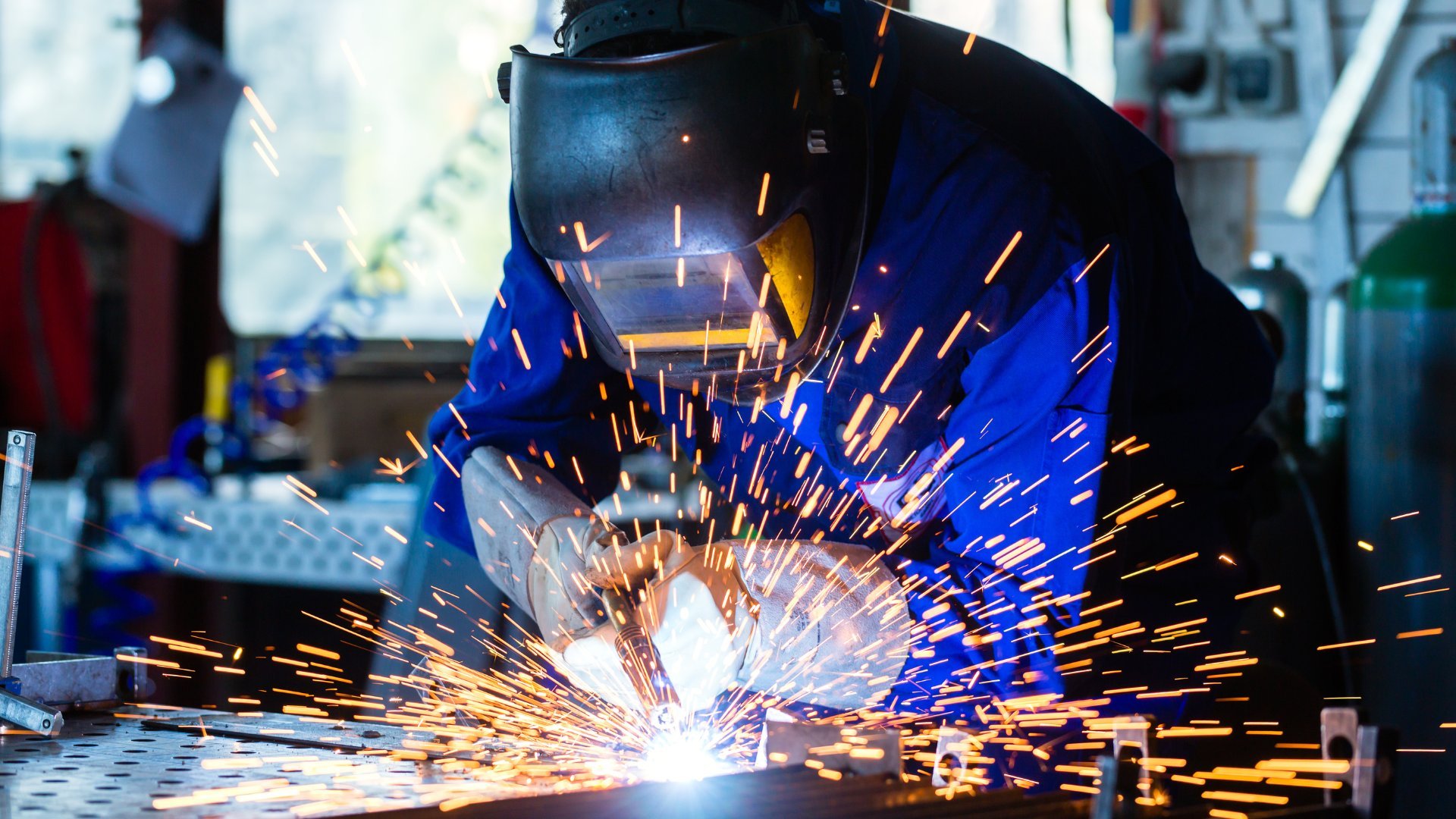 Welder striking an arc with sparks