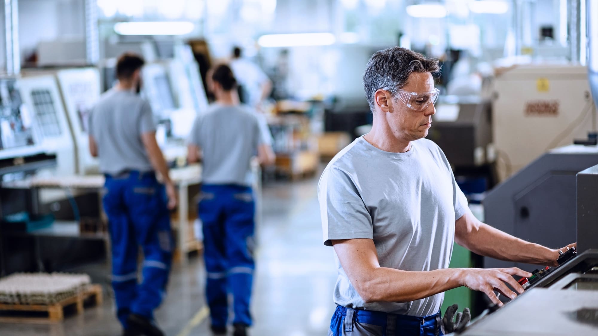 Plant manager and executive reviewing operations on a manufacturing floor