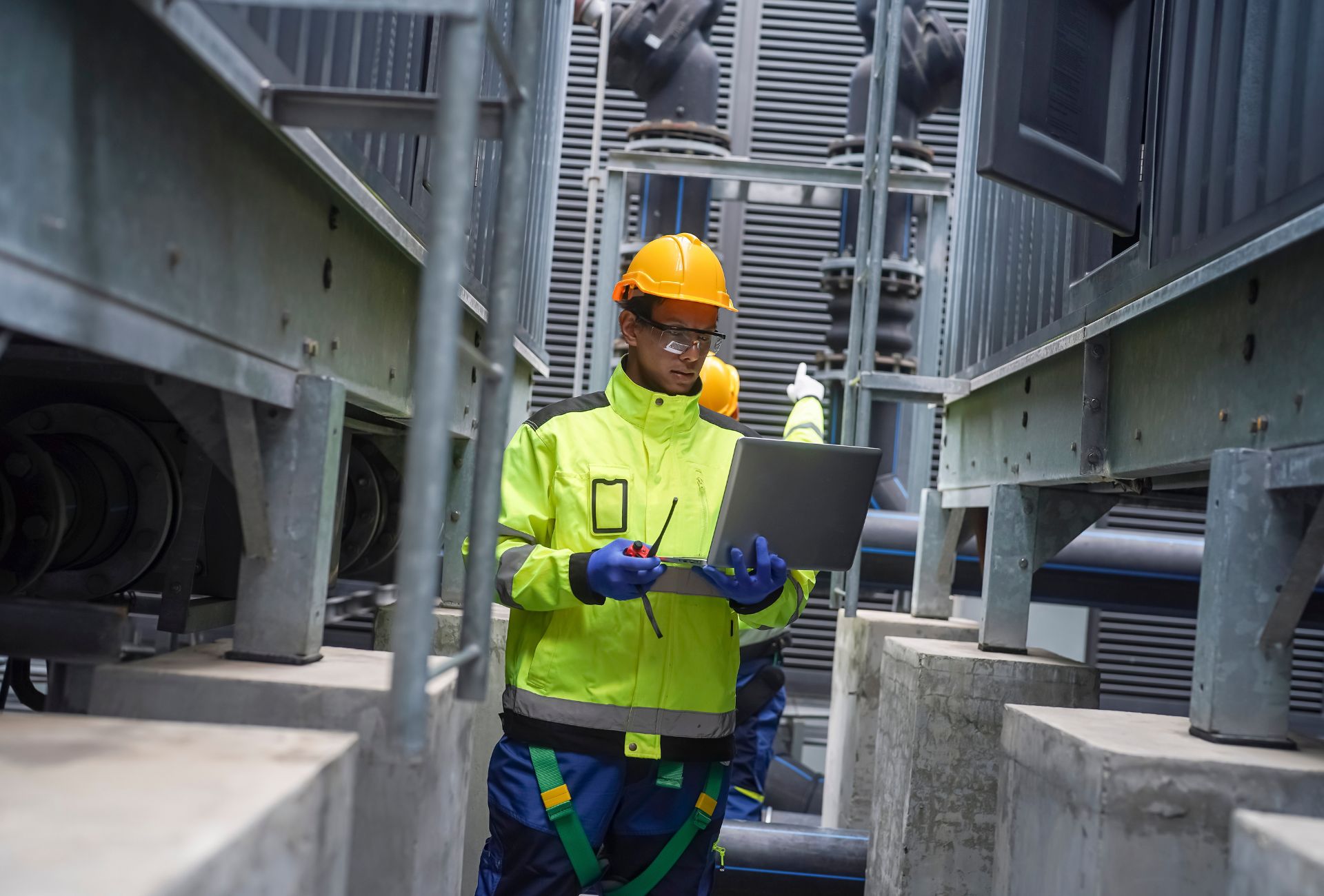 Engineer with laptop on industrial site