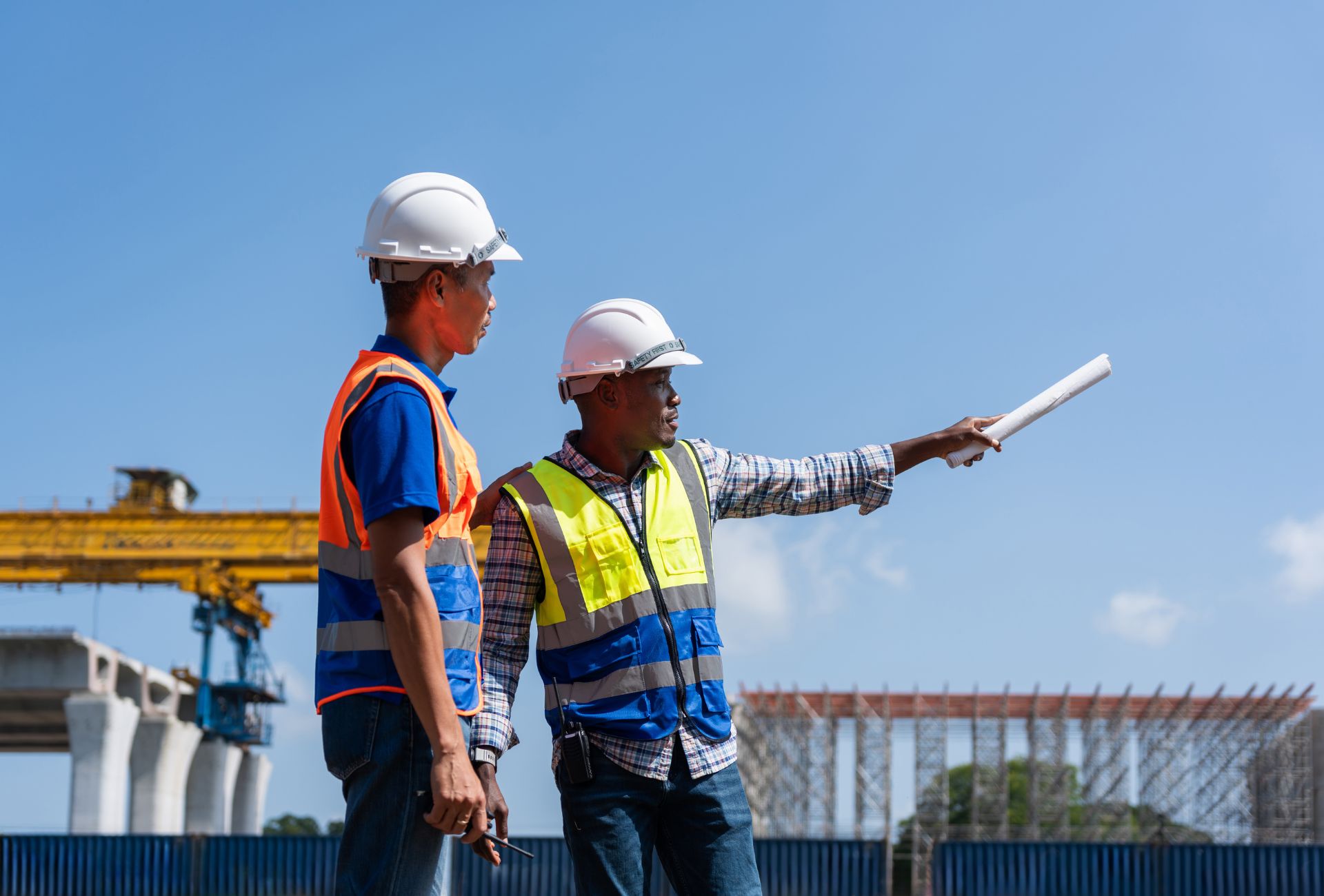 Two supervisors reviewing plans on site